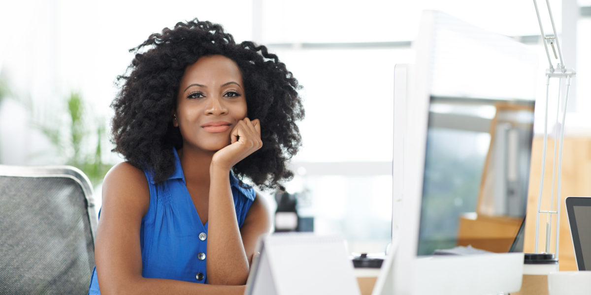 Portrait of attractive confident business lady at her workplace