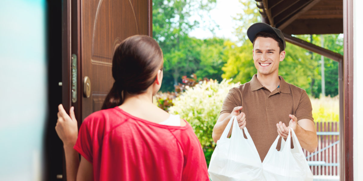 Delivery man delivering chinese take away food