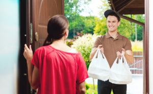 Delivery man delivering chinese take away food