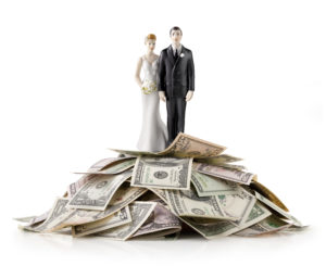 Heap of money with wedding cake topper