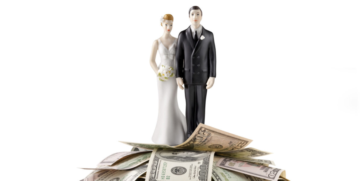 Heap of money with wedding cake topper