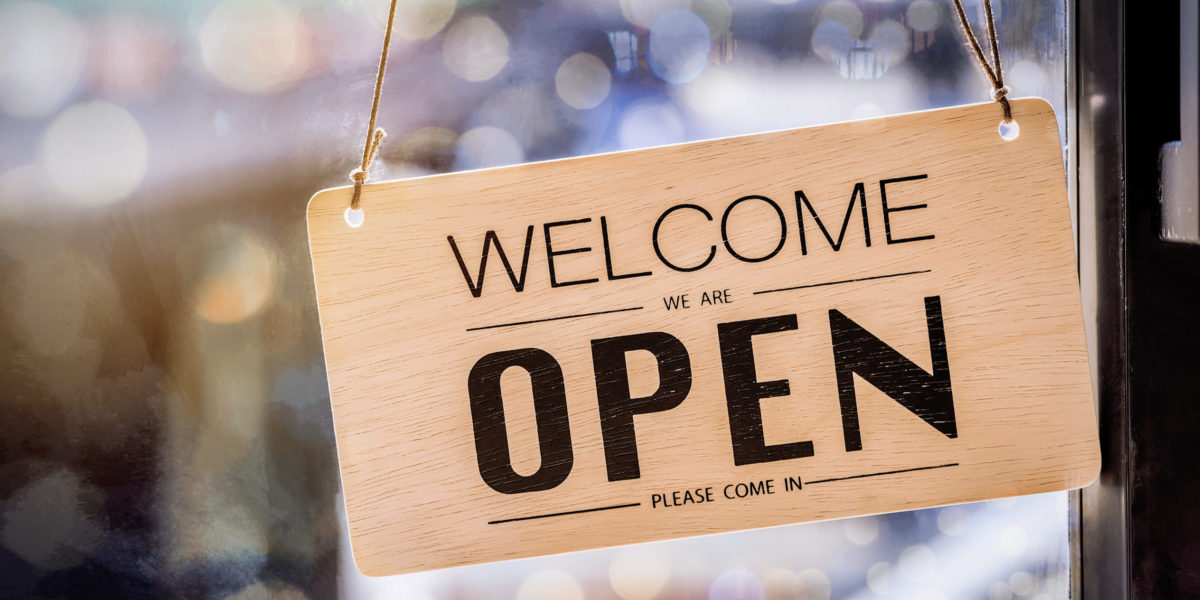 Wooden sign board hanging on door of cafe