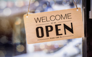 Wooden sign board hanging on door of cafe